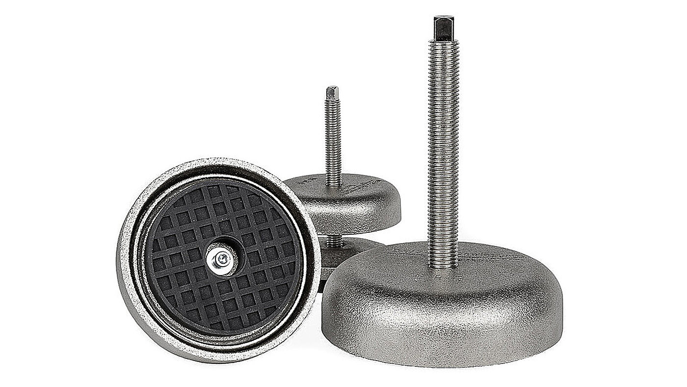rectangular group picture of three different-sized, round machine feet made of silvery shining, galvanized cast iron in bell shape, each with levelling screw with a top square shaft, one element in view from below with black elastomer NBR for vibration dampening and non-slip protection, isolated on white background
