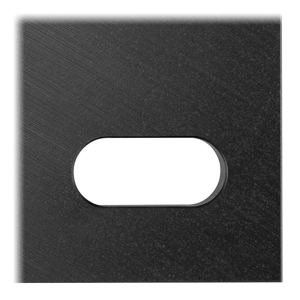 detailed view of the elongated hole of a black floor-fixture plate for levelling elements, made of precision-milled composite material, in the flat-lay view from above, isolated on white background