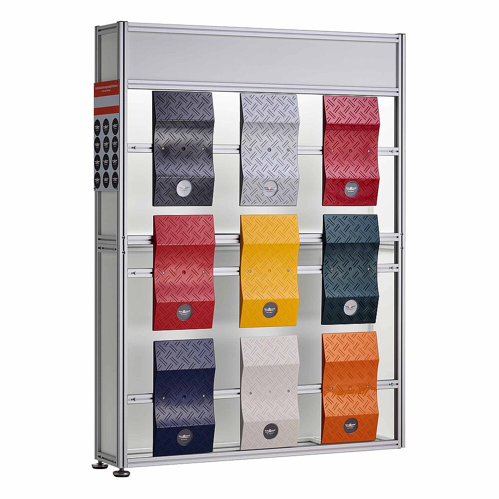 a tall, slim, dismountable product display made of aluminium profiles with nine vertically fastened, differently-coloured TyreGuard® tyre protectors on the front, mounted on two stainless steel levelling elements at the bottom, isolated on white background