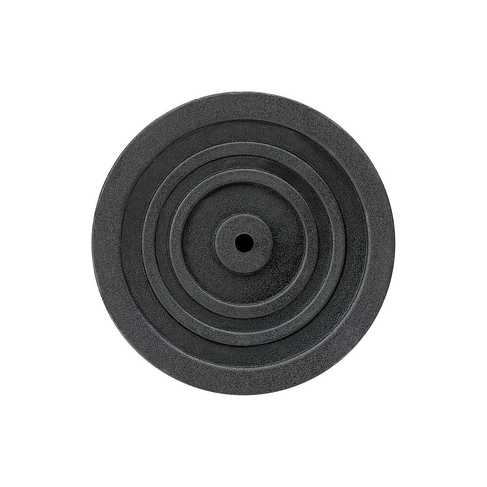bottom view of a round screw-in action levelling foot for machinery and appliances, made of black thermoplast elastomer, with 50 mm diameter and four concentric profiled rings for non-slip protection, isolated on white background