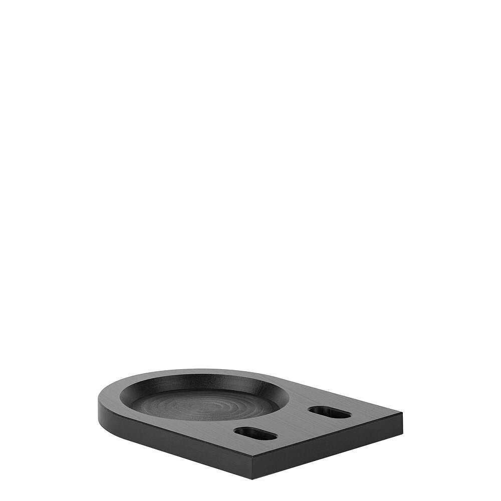 a black floor-fastening plate for levelling elements, made of precision-milled composite material, in the slanted side view, isolated on white background